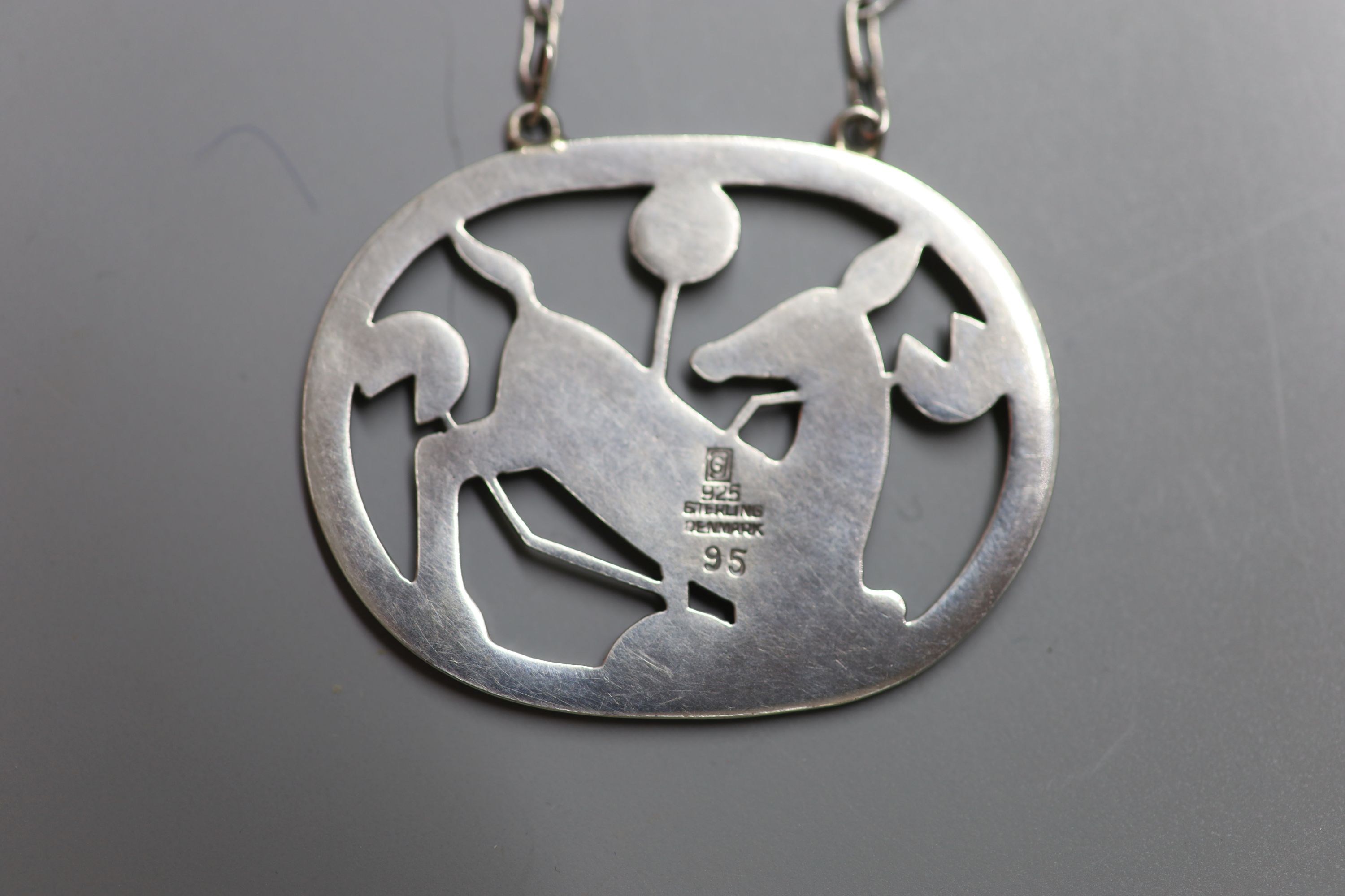 A Georg Jensen 925 kneeling deer oval pendant necklace, design no. 95, 42mm, gross 14.6 grams.